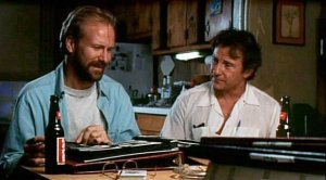 Auggie (Harvey Keitel) shows his photo lbum and listens to his friends comments